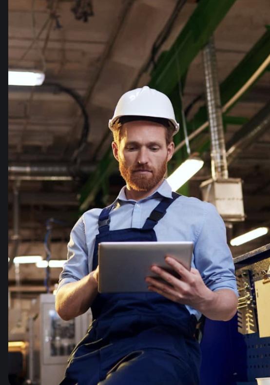Manufacturing professional reviewing production data